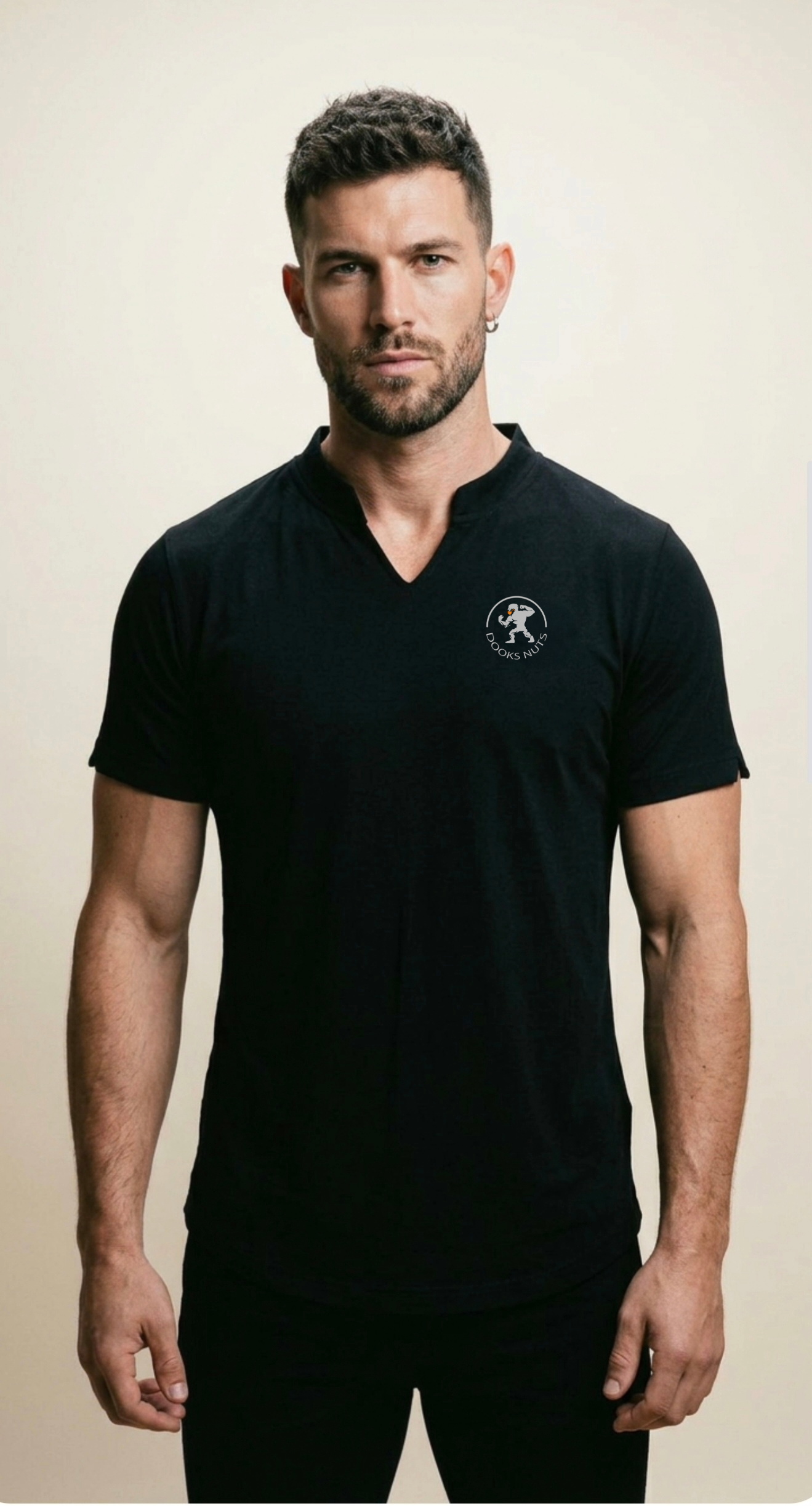 Man wearing a Dooks Nuts black t-shirt with a logo on a beige background