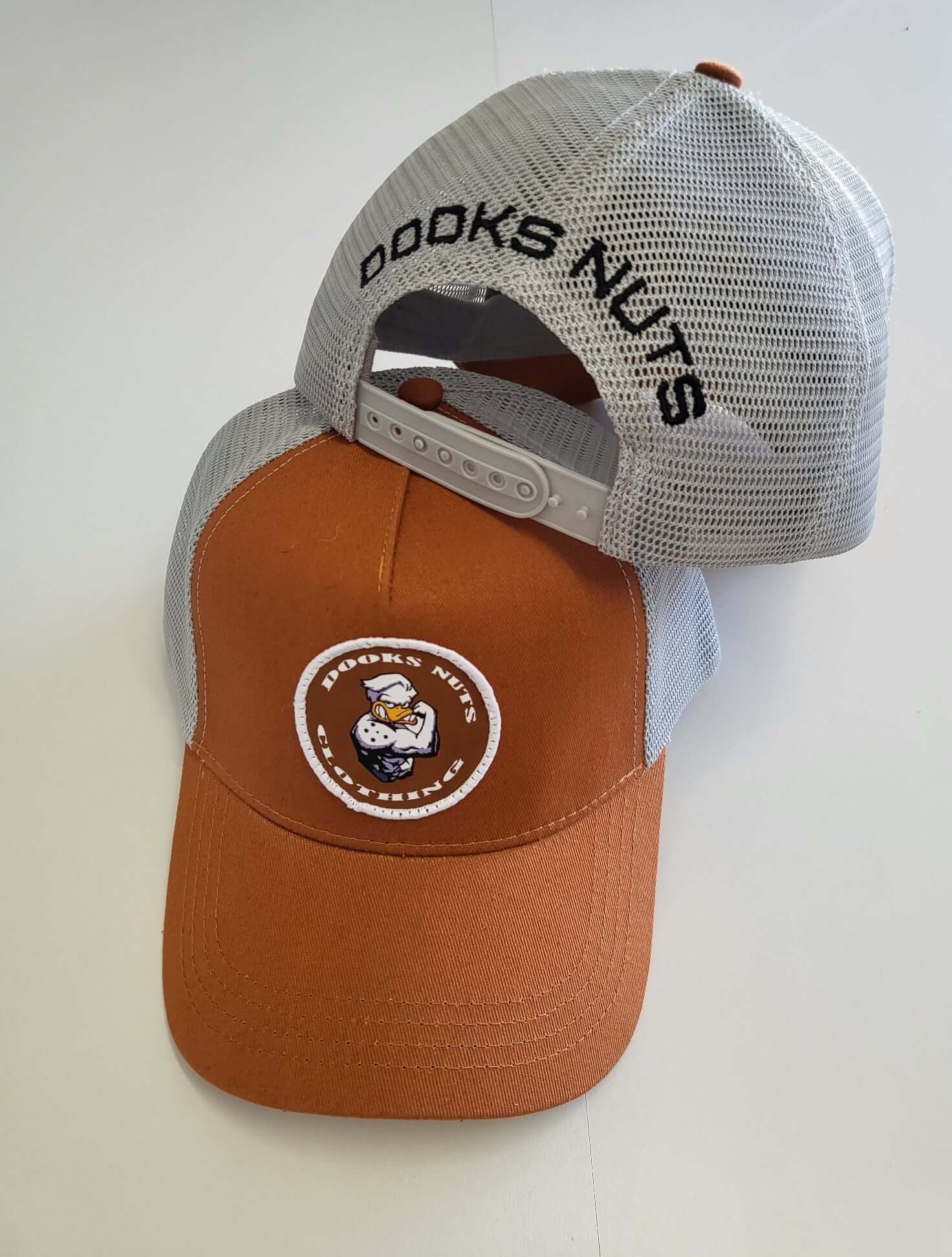 Dooks nuts truckers style tan and grey cap with patch logo.