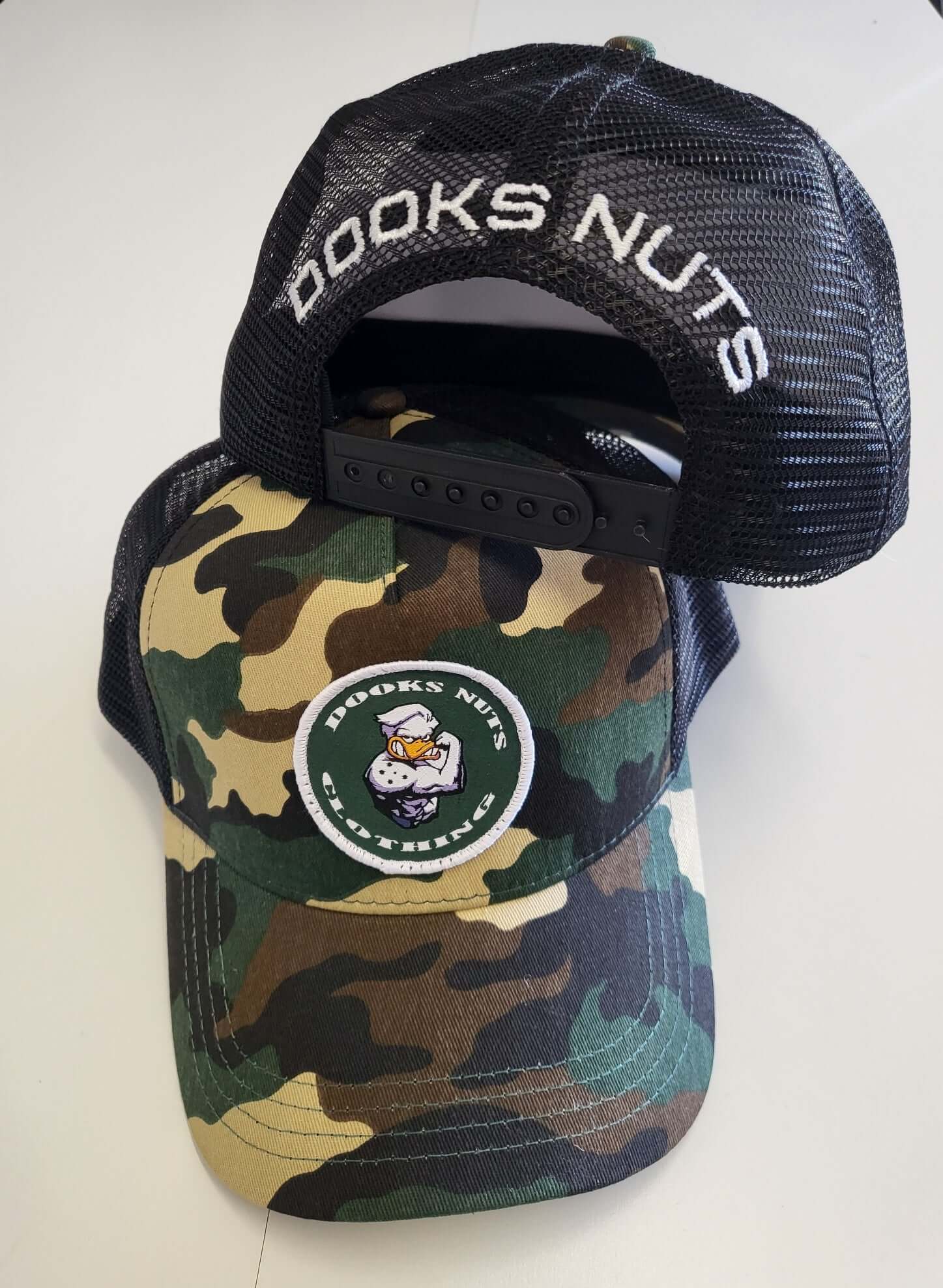 Dooks nuts truckers style cap-camo with patch logo.